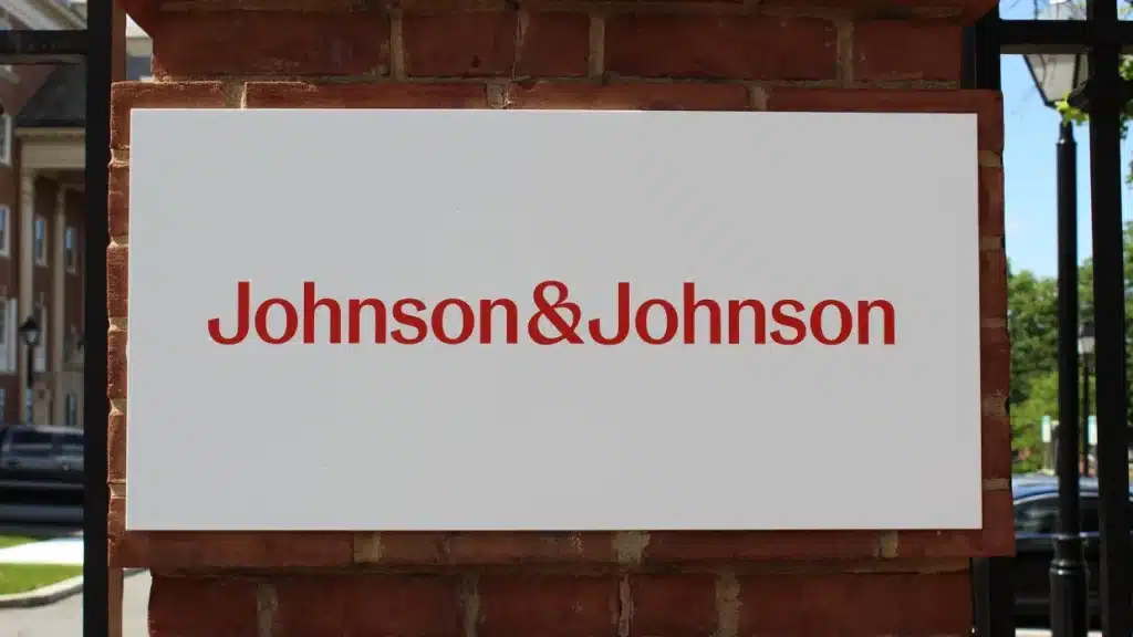 comprar ações da Johnson & Johnson, placa com novo logo da marca.